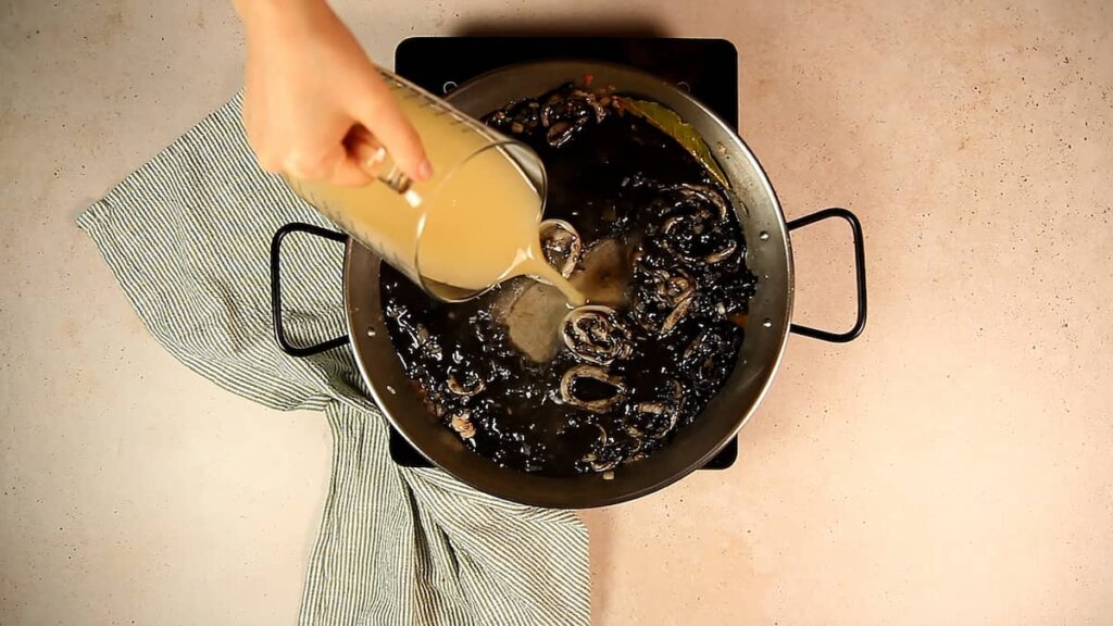 Receta de arroz negro con calamares y gambas. Paso 4: Incorporar el caldo